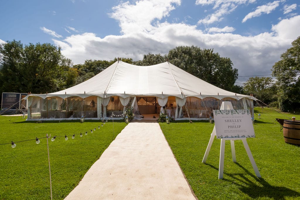 A pole marquee with an aisle leading to its entrance