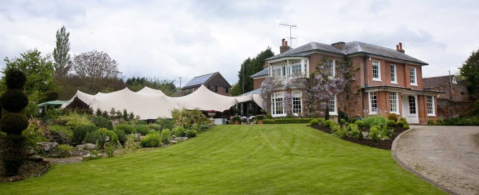 A stretch tent on a country house lawn